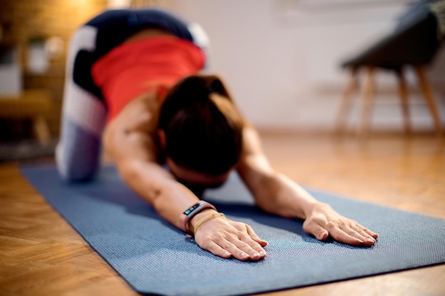 Closeup of athletic woman stretching on the floor at home