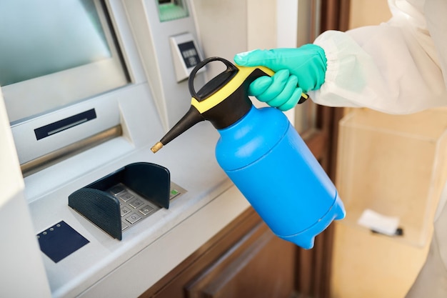 Closeup of ATM disinfection during coronavirus pandemic