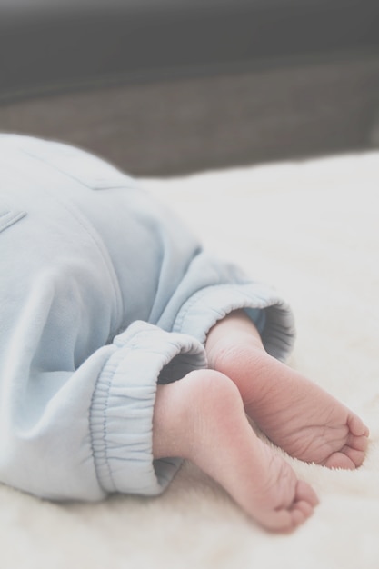 Closeup of baby's feet on a white blanket