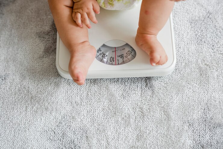 Free Photo closeup of a baby's legs on a weighing scale