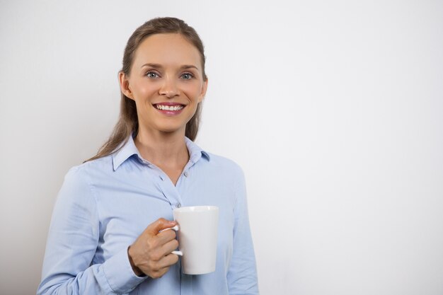 Closeup of Beautiful Smiling Woman Having Tea