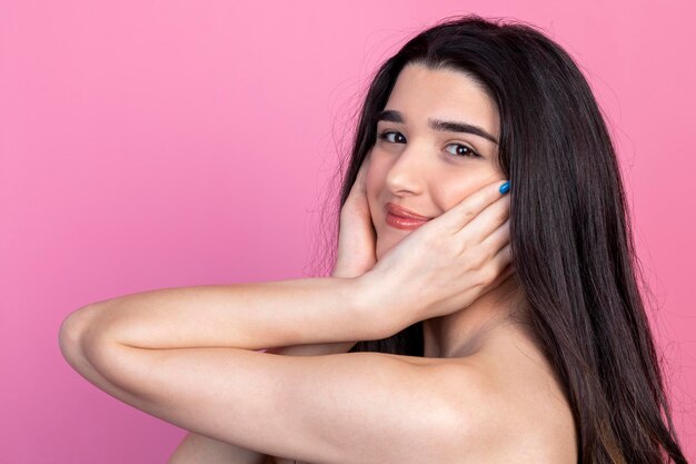 Closeup for beautiful woman holding her hands to her face and looking at the camera High quality photo