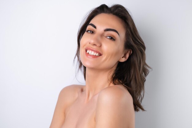 Closeup beauty portrait of a topless woman with perfect skin and natural makeup