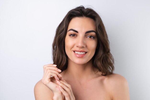 Closeup beauty portrait of a topless woman with perfect skin and natural makeup