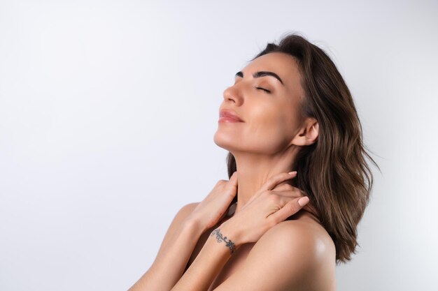 Closeup beauty portrait of a topless woman with perfect skin and natural makeup