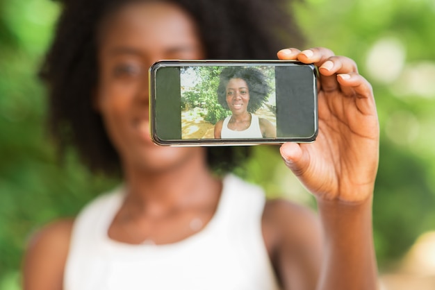 Closeup of Black Lady Taking Selfie Photo Outdoors