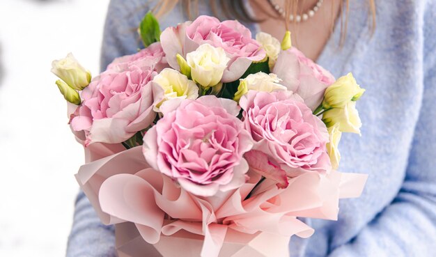 Closeup of a bouquet of roses in female hands