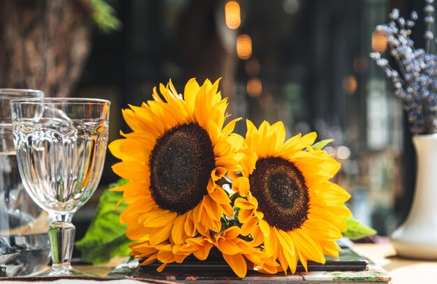 テーブルの上のカフェでひまわりの花束をクローズアップ