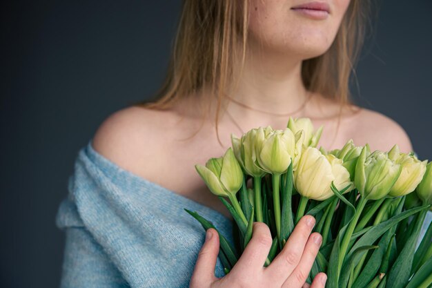 Closeup a bouquet of tulips in female hands