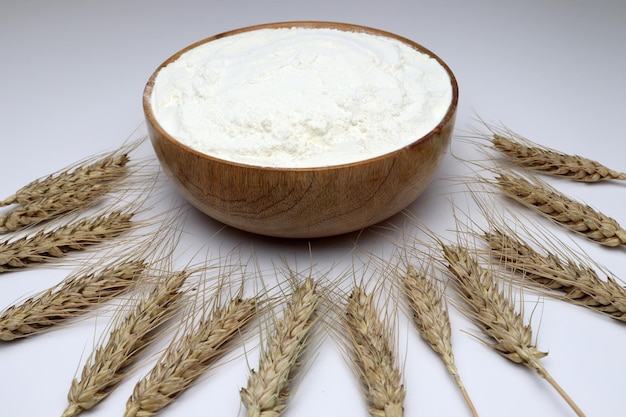 Free photo closeup of a bowl full of atta flour surrounded by ripe wheat