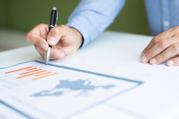 Closeup of business man analyzing bar chart