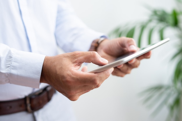 Closeup of business man browsing on tablet computer