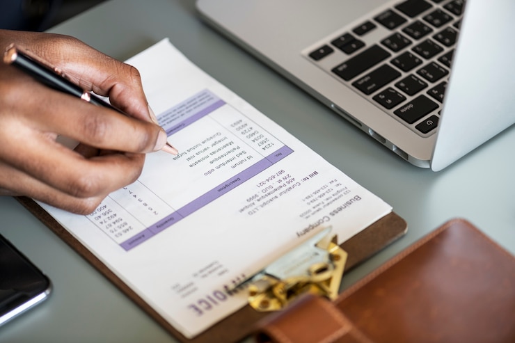 Free Photo closeup of business man checking tax invoice paper