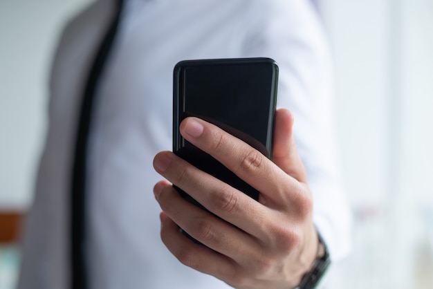 Closeup of business man holding smart phone
