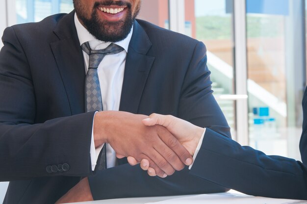 Closeup of business people shaking hands in outdoor cafe