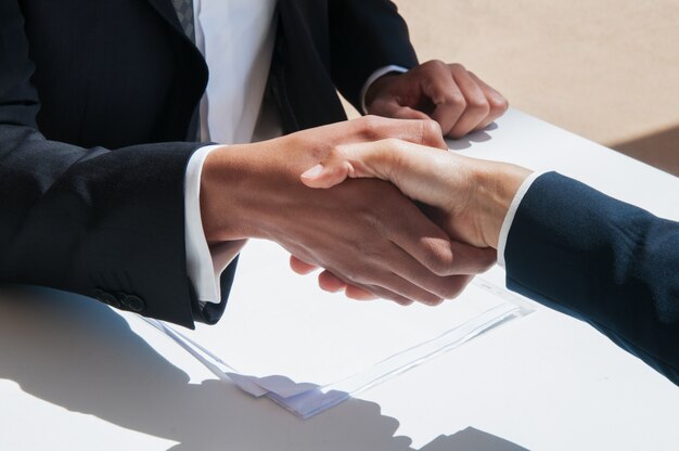 Closeup of business people shaking hands outdoors