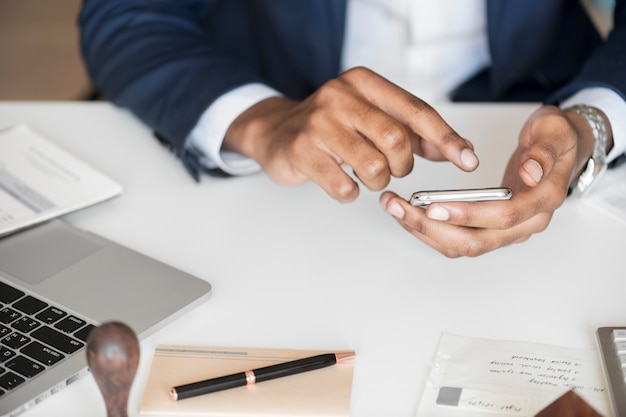 Free photo closeup of businessman using mobile phone