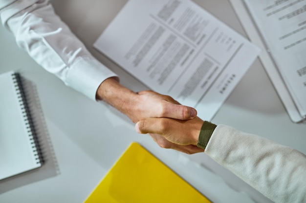 Closeup of businessmen shaking hands after successful agreement