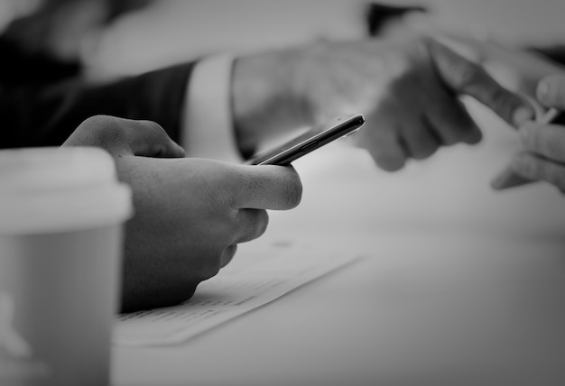 Closeup of businessmen using mobile phone