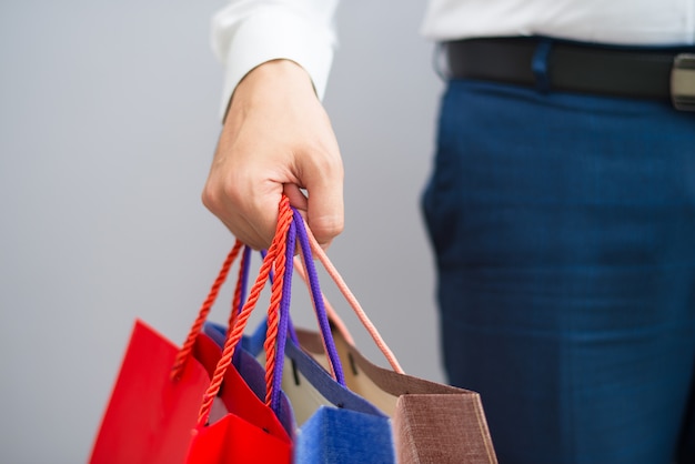 Closeup of buyer holding shopping bags