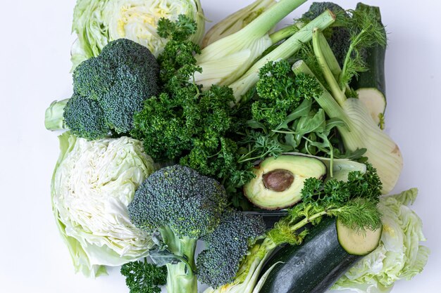 Closeup cabbage greens and avocado on a white background