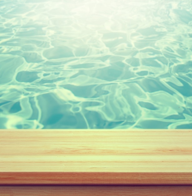 Free photo closeup clear wooden studio background beside swimming pool - well use for present products.