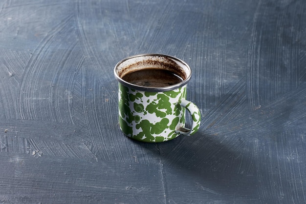 Closeup of coffee in a metal cup on a table