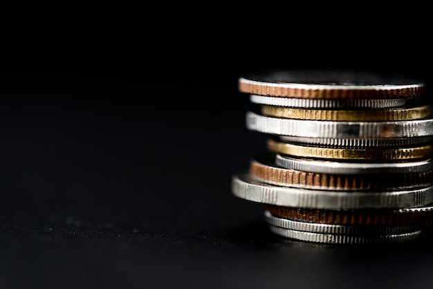 Closeup of coins stack isolated on black background