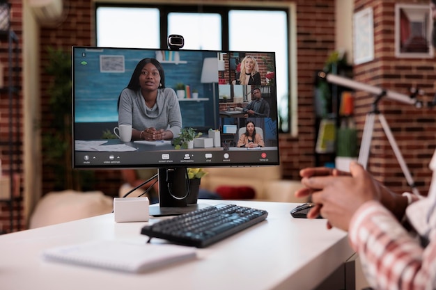 Free photo closeup of computer screen with african american startup owner and human resources team in online interview man gesturing. team of colleagues brainstorming business ideas in video call conference.