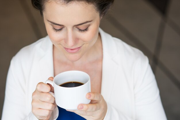 Closeup of Content Businesswoman Drinking Coffee