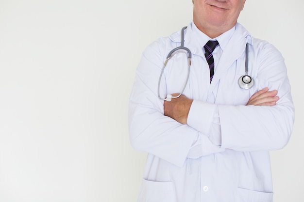 Closeup of Content Mature Doctor with Arms Crossed