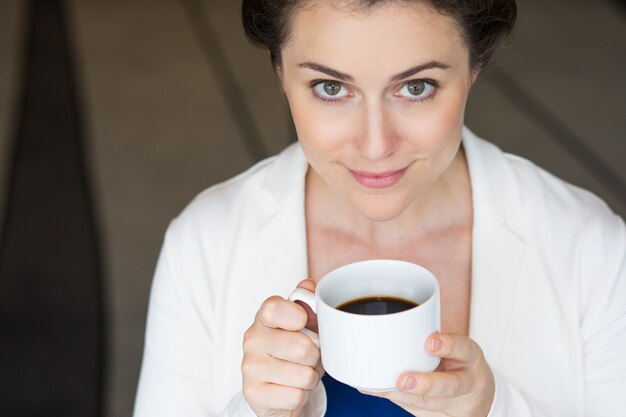 Closeup of Content Nice Businesswoman with Coffee