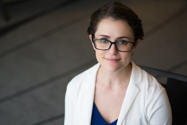 Closeup of Content Pretty Businesswoman in Glasses