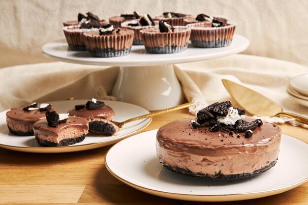 Closeup of creamy chocolate cheesecakes on plates on the table under the lights