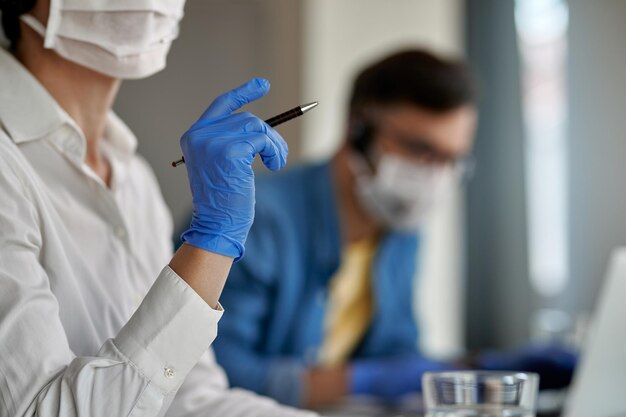 Closeup of customer service representative working at call center during virus epidemic