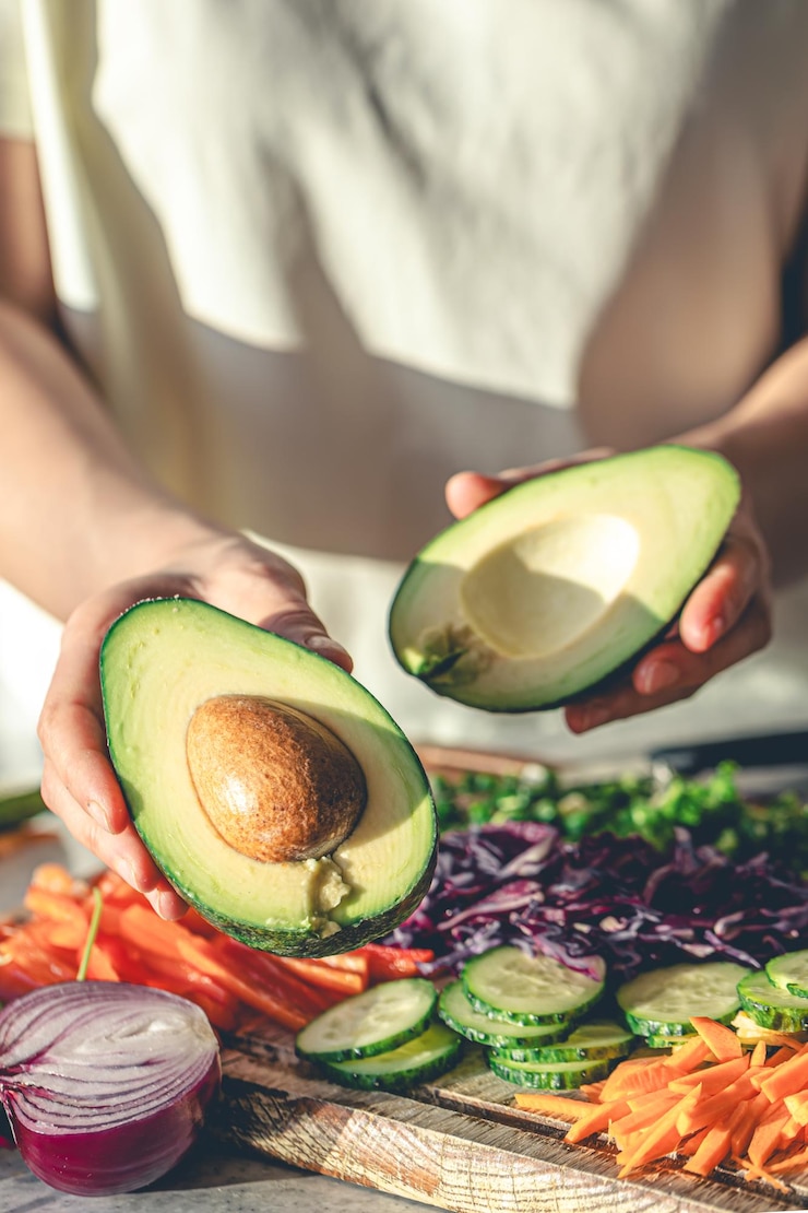 Free Photo closeup of a cut avocado in a womans hands