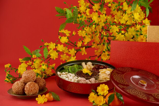 Closeup of delicious New Year food on a served table, red background