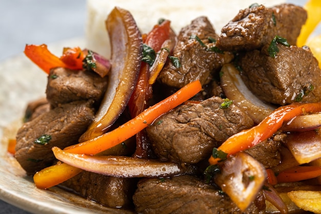 Closeup of delicious roasted meat with vegetables under the lights