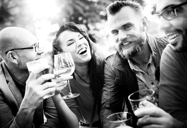 Closeup of diverse friends celebrating drinking together