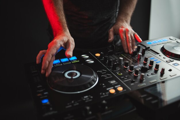 Closeup of a DJ working in studio