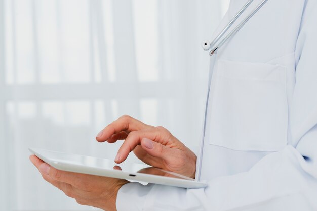 Closeup of doctor using tablet