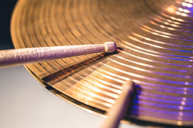 Closeup of drumsticks on a cymbal drum