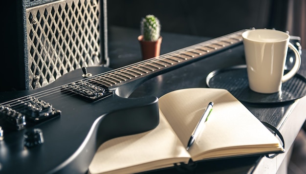 Closeup electric guitar and notepad concept of musical creativity