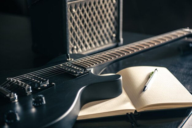 Closeup electric guitar and notepad concept of musical creativity