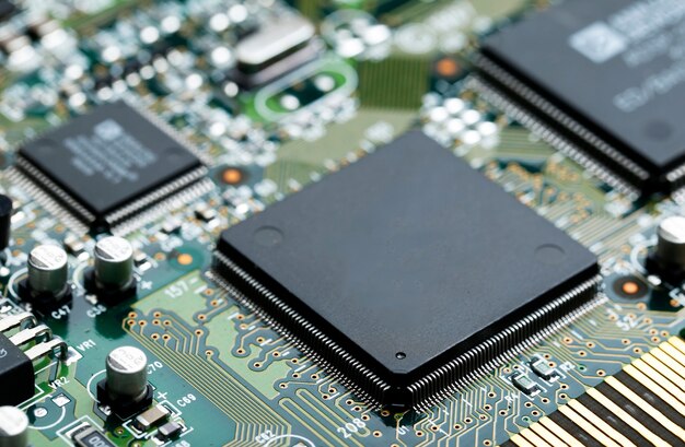 Closeup of electronic circuit board with CPU microchip electronic components background