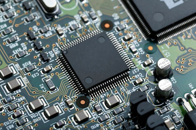 Closeup of electronic circuit board with CPU microchip electronic components background