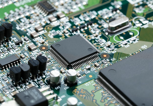 Closeup of electronic circuit board with CPU microchip electronic components background