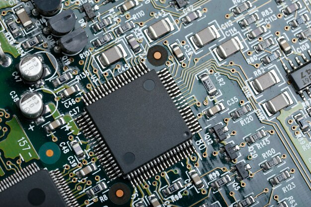 Closeup of electronic circuit board with CPU microchip electronic components background