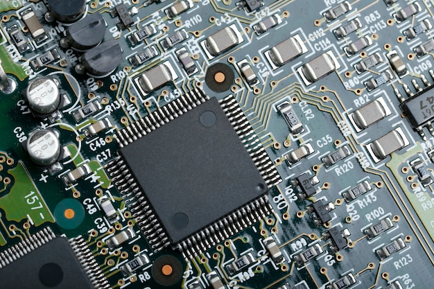 Closeup of electronic circuit board with CPU microchip electronic components background