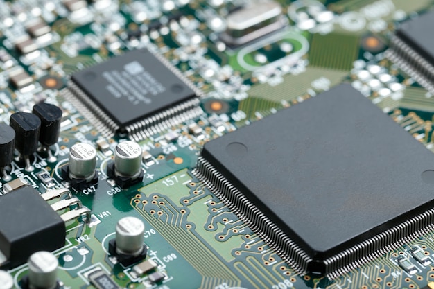 Closeup of electronic circuit board with CPU microchip electronic components background